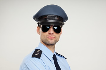 Portrait of handsome strict policemen in sunglasses