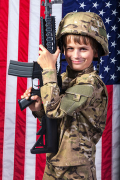 Young boy dressed like a soldier with American flag