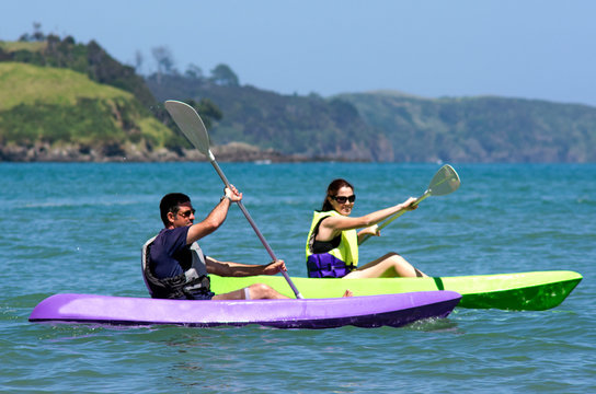 Couple kayaking at sea