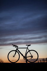 Obraz premium silhouette of race bike in sunset