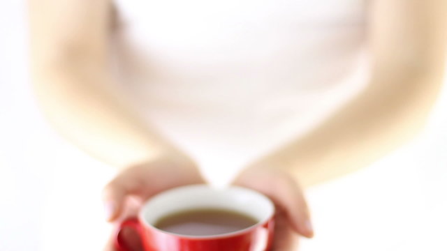 Hands Offering red cup of hot tea