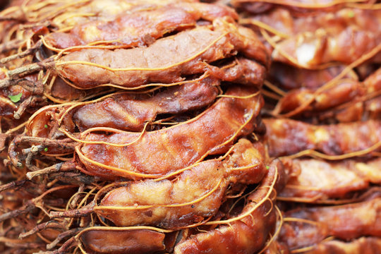 Background ripe tamarind fruit peeled.