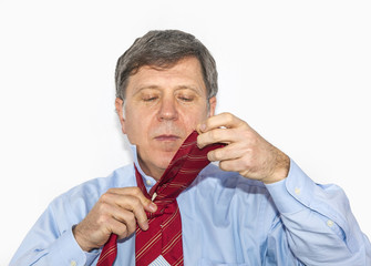 business man binds his tie
