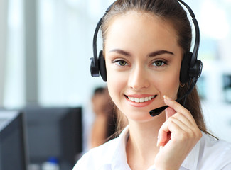 Female customer support operator with headset and smiling 