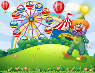 A hilltop with a clown and an amusement park
