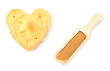 Heart of baked apple muffin and powdery cinnamon