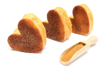 Hearts of baked apple muffins and powdery cinnamon