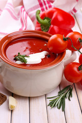 Tasty tomato soup and vegetables on wooden table