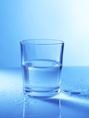Water in  glass, on dark blue background