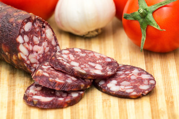 Smoked sausage on rural background