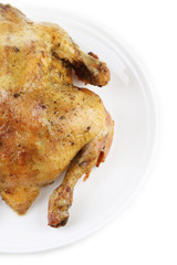 Whole roasted chicken on plate, isolated on white
