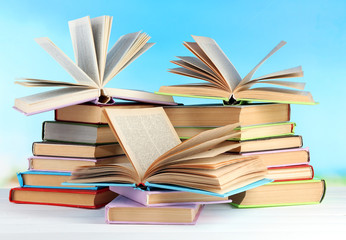 Stacks of books on table on natural background