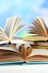 Stacks of books on table on natural background