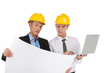 two professional builders looking at plan.