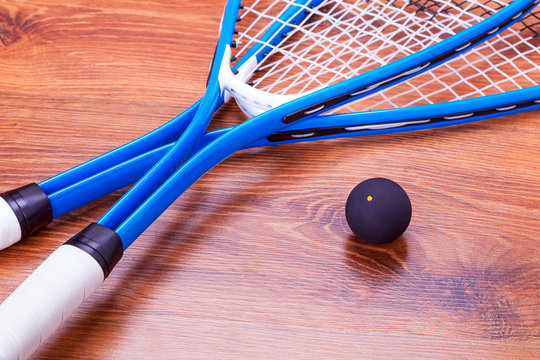Close up of a squash rackets and balls