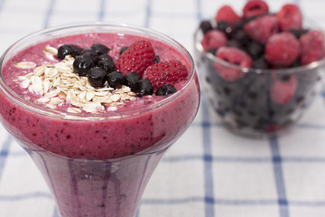 Cocktail of frozen raspberries, blueberries, muesli with yogurt.