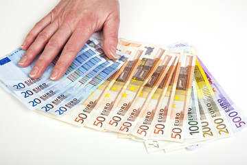 Hand fans out euro bills