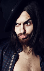 Obraz premium Portrait of a handsome man with a hat in the studio, closeup