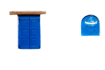 Blue shuttered window on a Greek house