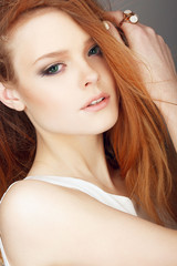 Portrait of beautiful girl with red hair