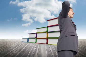 Composite image of thinking businessman scratching head