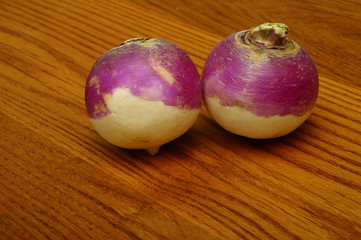 Purple turnips on wooden table