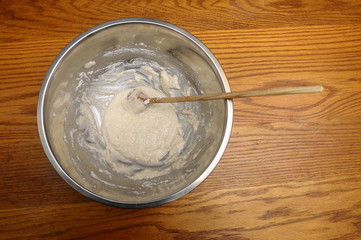 Mixing eggs white with sugar and almond in a bowl