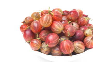 bowl of red gooseberries isolated, close-up