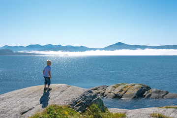 Fototapeta na wymiar Little boy enjoying view at fjord