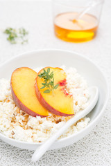 cottage cheese with honey, nuts, fresh peaches and thyme