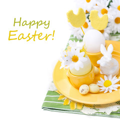 Festive Easter table setting with egg, rabbit and flowers