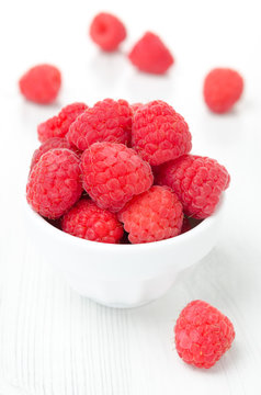 fresh raspberries in a bowl, vertical