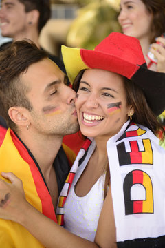 Sport soccer fans celebrating victory kissing.