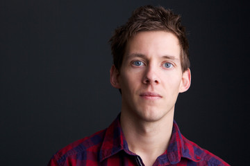 Man with blue eyes on gray background