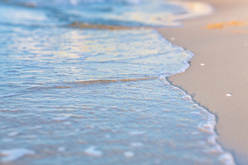 Fototapeta na wymiar Soft wave of the sea on a sandy beach