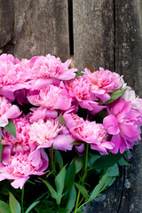 bunch of peonies on wooden surface
