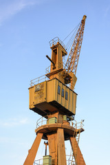 Old yellow crane with blue sky