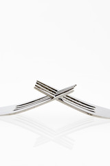Close up of fork isolated over white background with a little sh