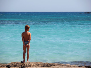 boy standing on the seashore