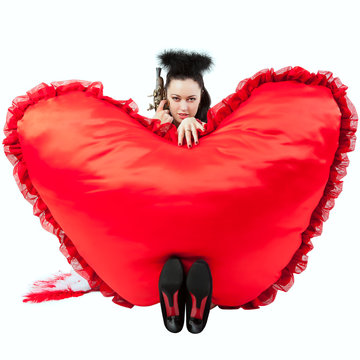 A girl with a heart in the form of pillows. Valentine's Day.