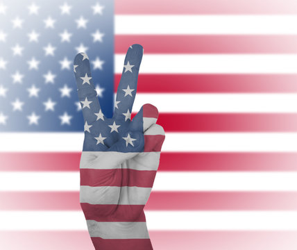 Hand peace sign with flag of the USA