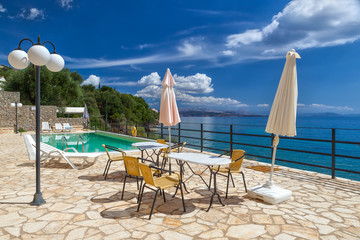 Tables and chairs standing near hotel pool