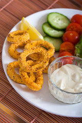 Fried breaded calamari with vegetables
