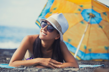 beautiful girl is sunbathing on the beach