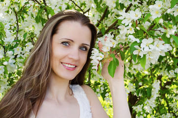 Portrait of beautiful  woman with apple tree flowers