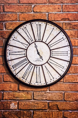 Old vintage clock on textured brick wall