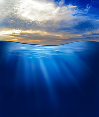 sea or ocean underwater with sunset sky