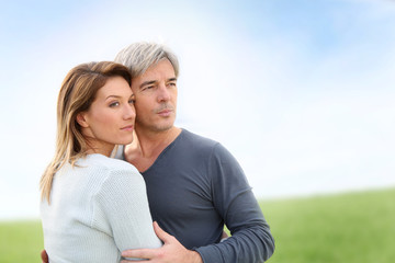 Peaceful middle-aged couple in countryside