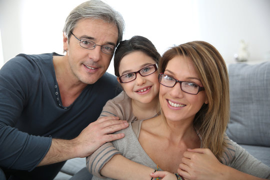 Portrait of family of 3 people wearing eyeglasses