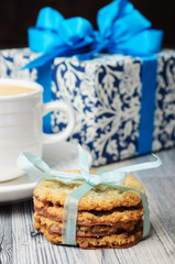 Cookies, white cup and a blue gift box